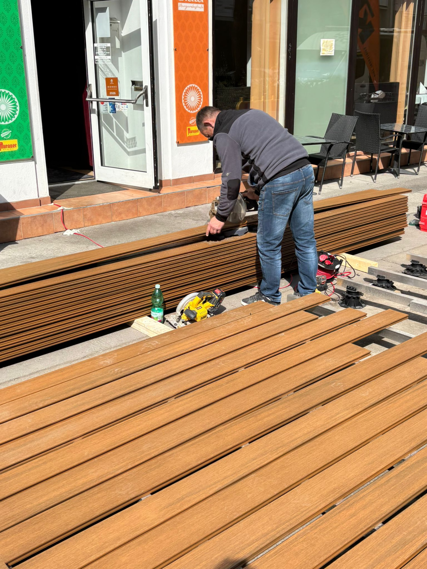 Zuschnitt der Terrassendielen beim Pergola-Projekt für Taste Of India